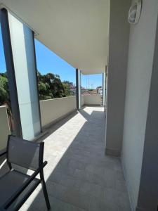 a chair on the balcony of a building at La Romantica in Riccione
