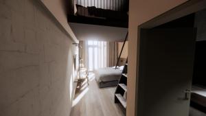 a room with a bed and a room with a hallway at Centrum Hotel in Akureyri