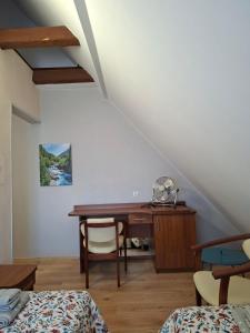 a room with a desk and a table with a chair at L&B House in Malbork