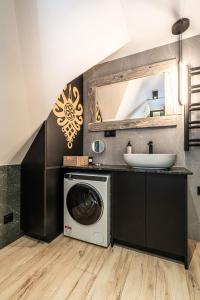 a bathroom with a washing machine and a sink at Apartamenty Premium VIEW JACUZZI & SAUNA in Kościelisko +128 photos