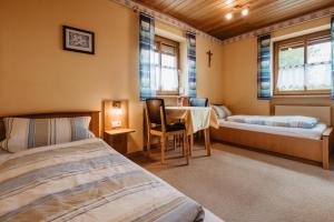 a room with two beds and a table in it at Gäste-Haus Rösch in Wiesent