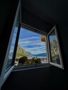 a window in a room with a view of a mountain at Apartman Vujović Orahovac in Trstenik