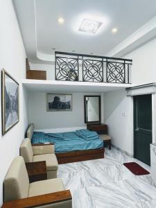 a living room with a bed and a couch at The F House in Danang