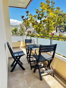 two chairs and a table on a balcony at Villa Niku Berat in Berat