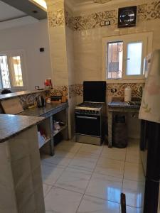 a kitchen with a stove and a counter top at Um yousef house in Alexandria