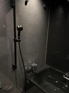 a bathroom with a shower with a bath tubscribed at Guesthouse Lavande in Chino +19 photos
