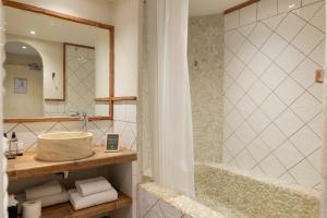 a bathroom with a sink and a bath tub at Casa Santini x Roc Seven in Porto-Vecchio +141 photos