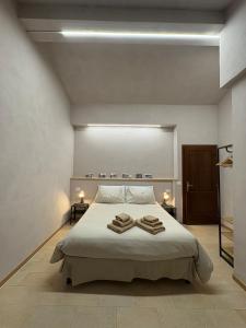 a bedroom with a bed with two towels on it at Hotel Regina Yeti Bistrot in Sestola
