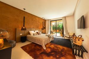 a bedroom with a bed and a large window at Villa Madjha Ecolodge Marrakech in Marrakesh +101 photos