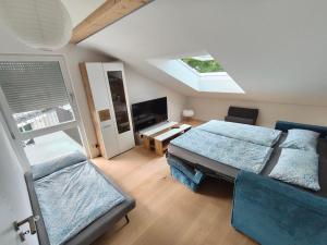 a bedroom with two beds and a skylight at Am Weiher mit Terrasse in Hergensweiler