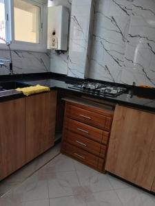 a kitchen with a sink and a counter top at Casa youssef 2 in Asilah +18 photos