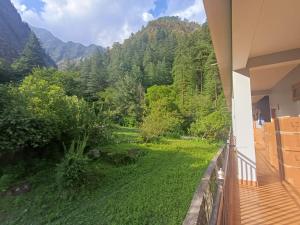 a balcony with a view of the mountains at Pratham Place in Kasol
