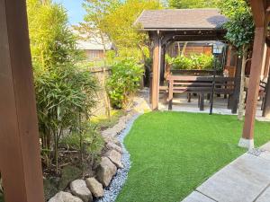 a garden with green grass and a picnic table at Biwako Villa 縁 in Takashima