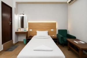 a hospital room with a bed and a chair at Subhash Hotel in Prayagraj +99 photos