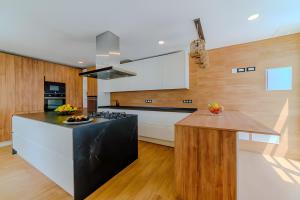 a kitchen with a black and white stove and a counter at Villa De Marcos in Arona