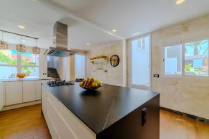 a kitchen with a bowl of fruit on a counter at Villa De Marcos in Arona +31 photos