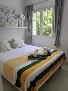 a bedroom with a bed with towels on it at Menorca Villa Marbella in Son Parc +19 photos