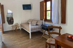 a small room with a bed and a table at Apolafsis Studios in Patmos