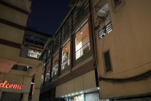 a person looking out the window of a building at night at Subhash Hotel in Prayagraj