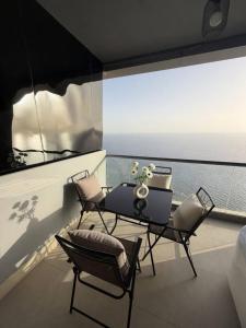a dining room with a table and two chairs at برج داماك الكورنيش - Damac Al-Corniche Tower in Jeddah