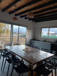 a dining room with a large table and chairs at Quincho Lelita in Zonda