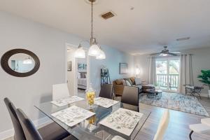 a dining room and living room with a table and chairs at Cypress Cove 111 in Melbourne