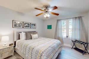 a bedroom with a bed and a ceiling fan at Cypress Cove 111 in Melbourne +27 photos