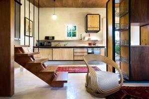 a living room with a chair and a kitchen at be&be castlemaine in Castlemaine