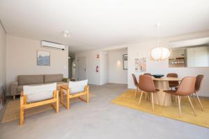a living room with a table and chairs and a couch at Rivara Rooftop By ALGARTUR in Cabanas de Tavira +33 photos