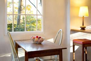 a table and chairs with a bowl of fruit on it at be&be in Castlemaine