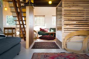 a living room with a staircase and a couch at be&be castlemaine in Castlemaine