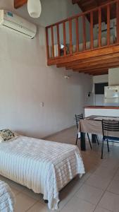 a bedroom with a bed and a table with chairs at La Liebre in Federación
