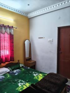 a bedroom with a bed and a mirror and a window at VS valley view resorts in Kotagiri