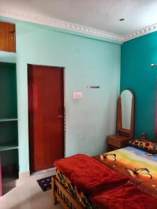 a bedroom with a bed and a red door at VS valley view resorts in Kotagiri