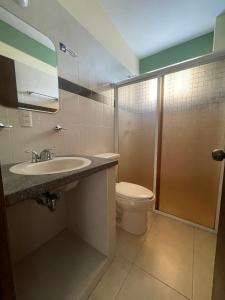 a bathroom with a toilet and a sink and a shower at Hotel Casa Rus in Comitán +46 photos