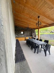 a dining table and chairs under a wooden ceiling at Maison en Auvergne - Chez Julien et Stephy in Celles +15 photos