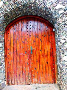 a large wooden door in a stone wall at Gite Oussalem timichi in Timichchi