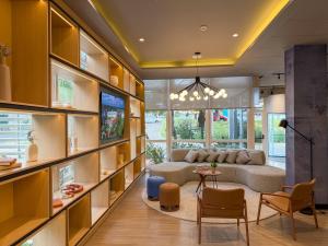 a living room with a couch and a table at ibis Canoas Shopping in Canoas