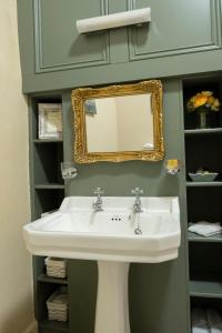 a bathroom with a white sink and a mirror at Corrib House Guest Accommodation in Galway +62 photos