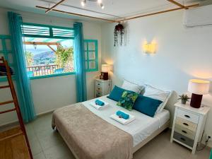 a bedroom with a bed with two towels on it at Espace Harmonie Deshaies - Vue Mer & Piscine Panoramique in Deshaies