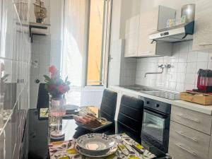 a kitchen with a table and chairs and a counter top at Apartment casa JS by Interhome in Imperia