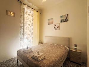 a bedroom with a bed with towels on it at Apartment casa JS by Interhome in Imperia +19 photos