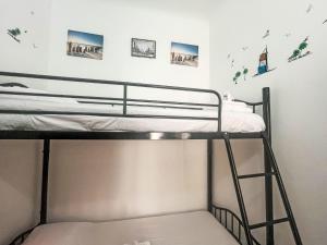 a bunk bed in a room with photos on the wall at Apartment casa JS by Interhome in Imperia