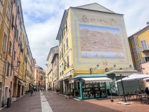 a street with a large mural on the side of a building at Apartment casa JS by Interhome in Imperia