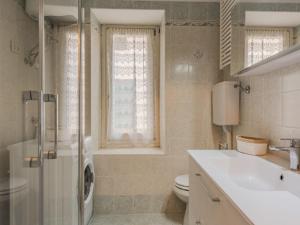 a bathroom with a shower toilet and a sink at Apartment Catherine by Interhome in Pellizzano