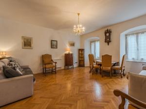 a living room with a couch and a table and chairs at Apartment Catherine by Interhome in Pellizzano