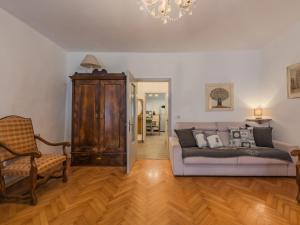 a living room with a couch and a chair at Apartment Catherine by Interhome in Pellizzano +18 photos