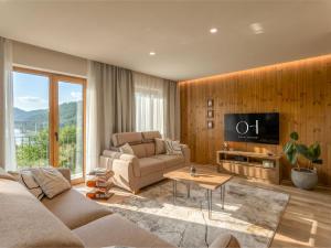 a living room with a couch and a tv at Villa Orso by Interhome in Fužine