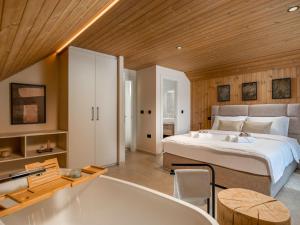 a bedroom with a large bed and a bath tub at Villa Orso by Interhome in Fužine