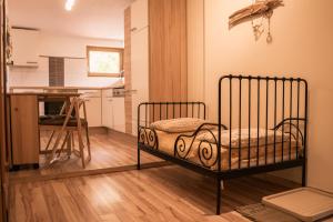 a bedroom with a bed in a room with a kitchen at Landhaus am Hügel in Bad Gastein